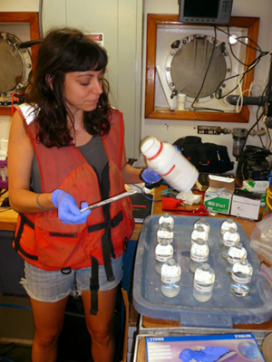 Alex Harper collects seawater samples from CTD Rosette Niskin bottles aboard R/V Weatherbird II. (Photo credit: Natalie Geyers)