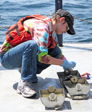 Sarah collects sediment samples for DNA analysis on board the Florida Institute of Oceanography R/V Bellows. (Photo Credit: Richard Snyder)