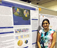Devika standing by her poster at an entomology conference. (Provided by Claudia Husseneder)